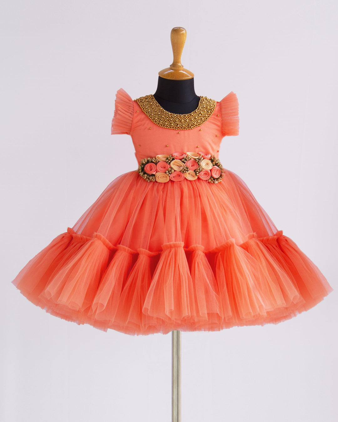 Coral Peach Shade Handwork Flower Frock
Material: Coral peach shade handwork flower frock is made with soft nylon net fabric. The yoke portion of the frock is designed with handwork design. Golden colour