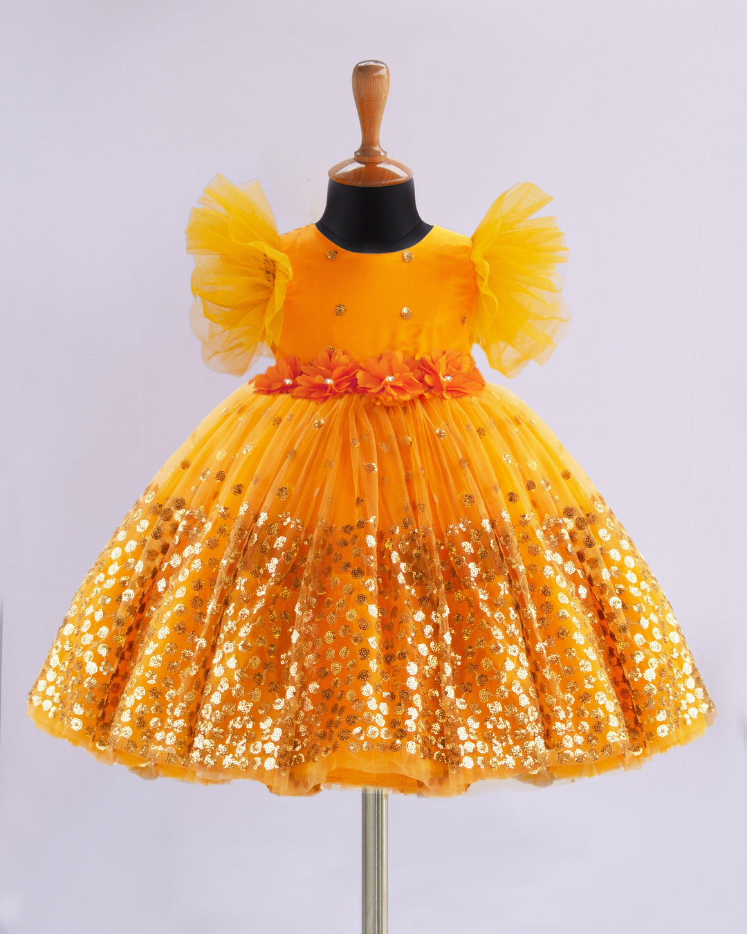 Mango Yellow Shade Heavy Sequins Party-wear Frock
Material : Mango Yellow Shade heavy sequins fabric net is used in the upper portion of the skirt. In the second layer pleated net is used for the grand and puffy lo