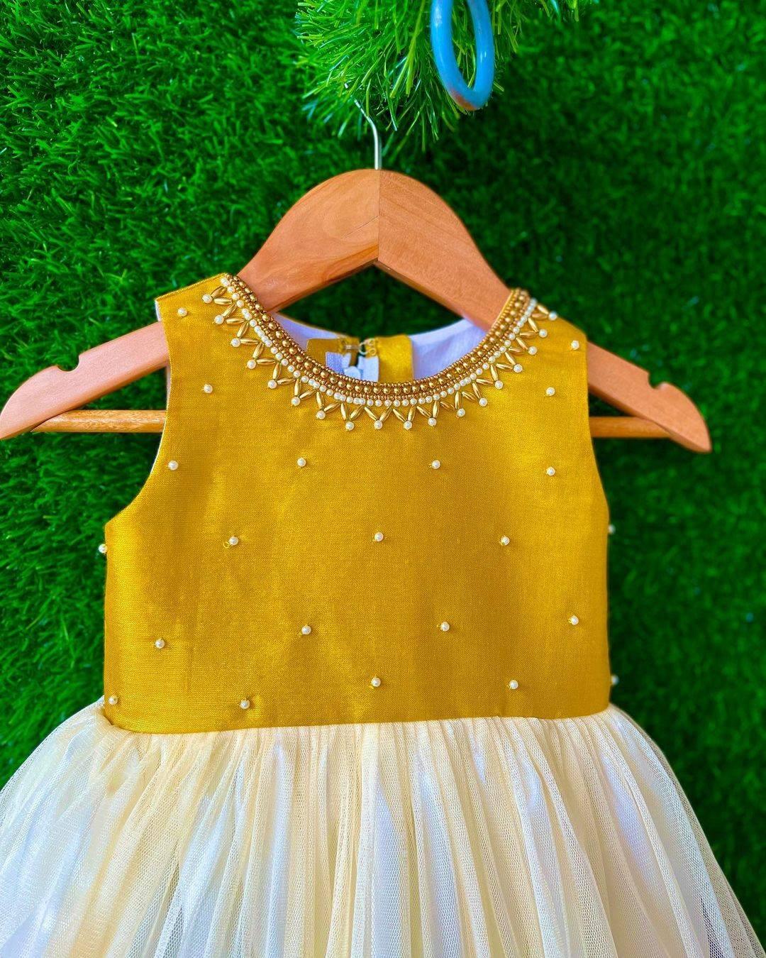 Cream & Gold handwork Traditional Knee Length Frock
Material:  Cream & Gold soft quality net with premium cream ultra satin inside for shining, Meroon silk material with hand embroidery beads on the neck and body