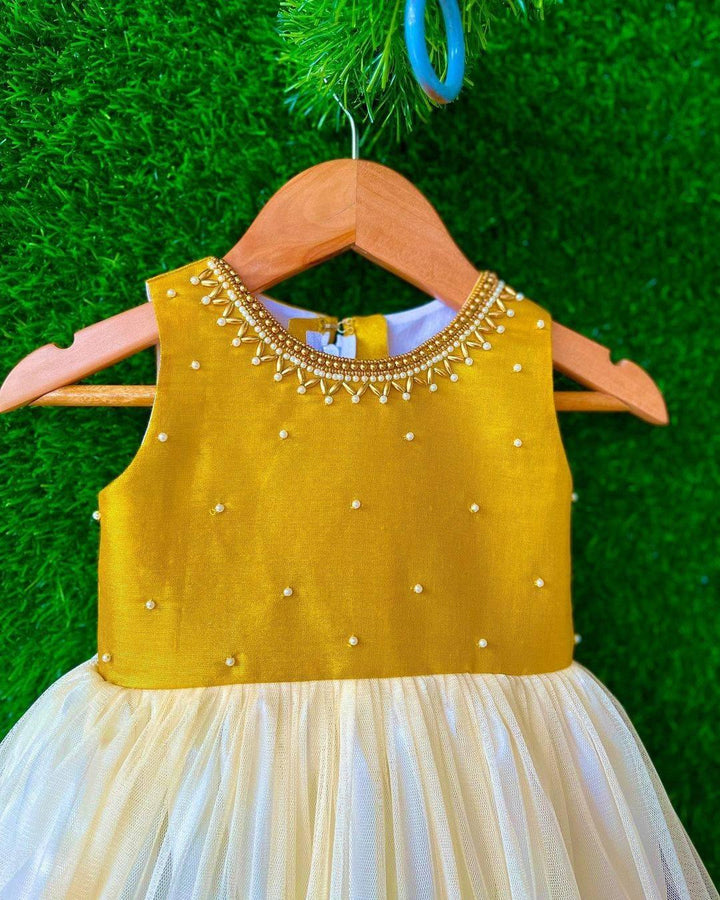 Cream & Gold handwork Traditional Knee Length Frock
Material:  Cream & Gold soft quality net with premium cream ultra satin inside for shining, Meroon silk material with hand embroidery beads on the neck and body
