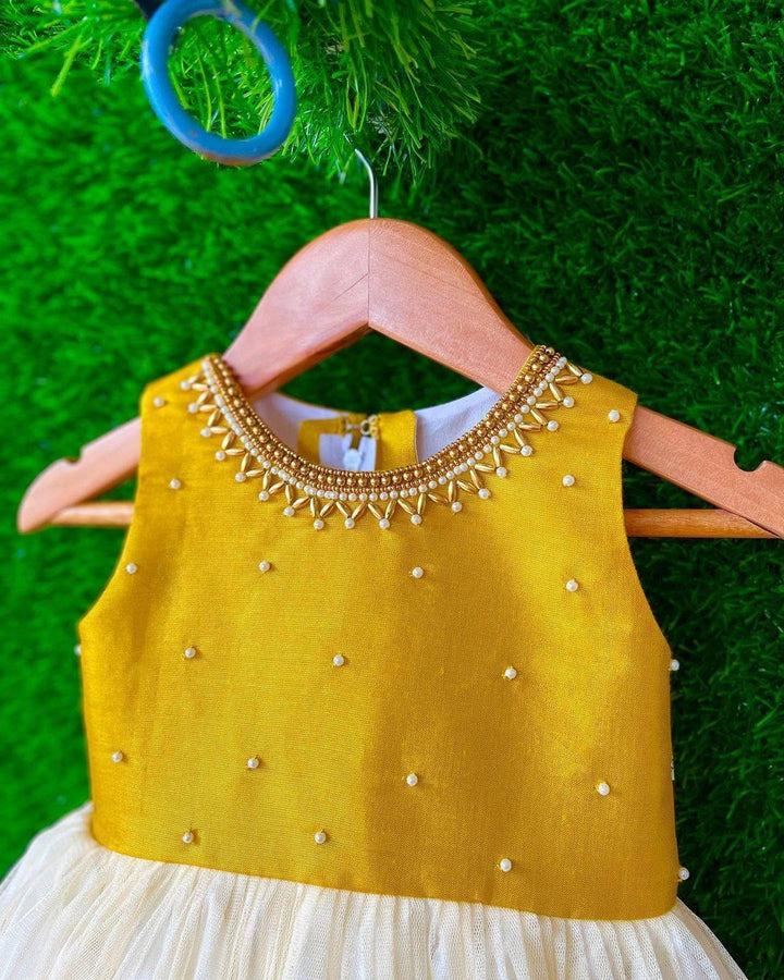 Cream & Gold handwork Traditional Knee Length Frock
Material:  Cream & Gold soft quality net with premium cream ultra satin inside for shining, Meroon silk material with hand embroidery beads on the neck and body
