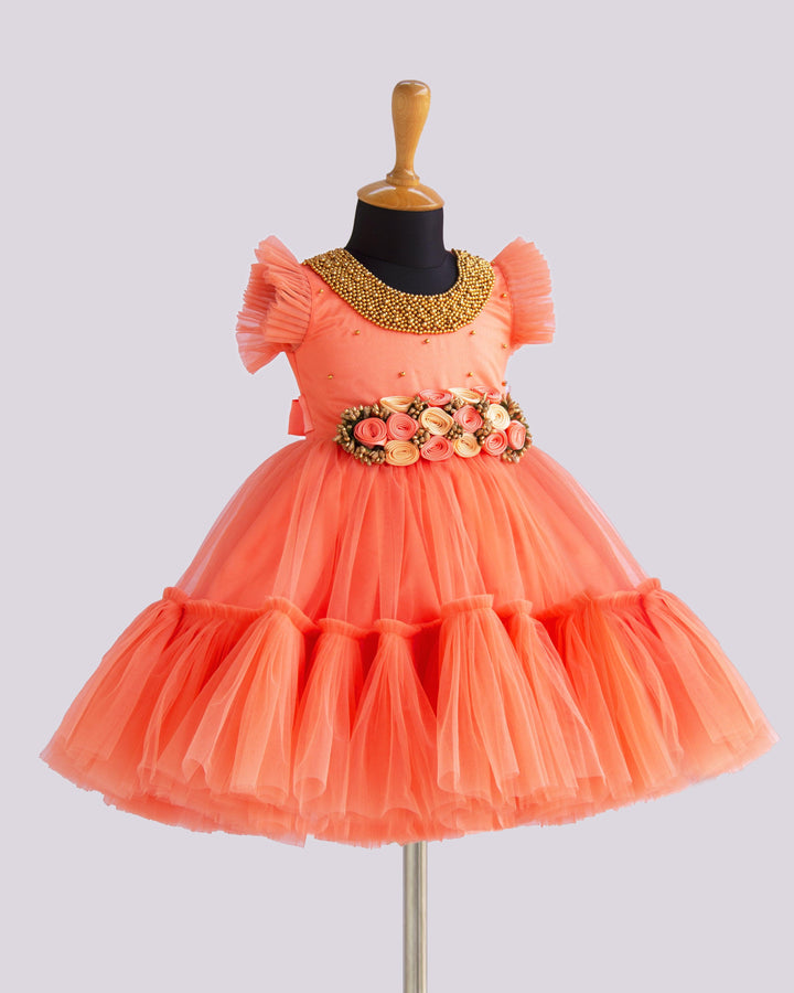 Coral Peach Shade Handwork Flower Frock
Material: Coral peach shade handwork flower frock is made with soft nylon net fabric. The yoke portion of the frock is designed with handwork design. Golden colour