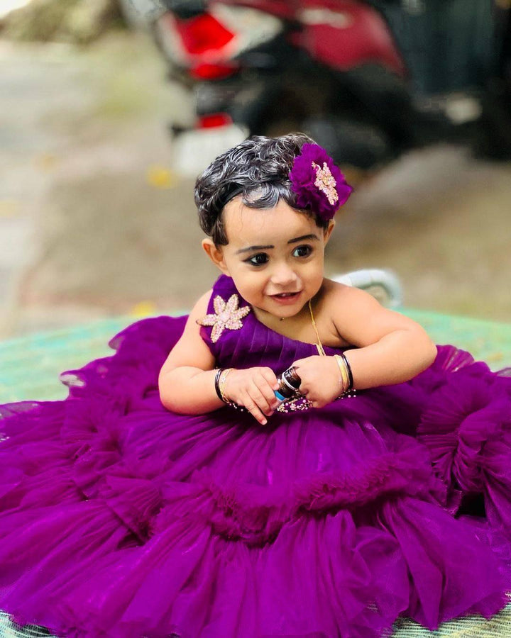Aishu's Purple Shade Pleated Ruffled Frock
Material: Aishu's Purple Shade Pleated Ruffled Frock mono net with layered and ruffles on the end portion. Yoke portion is designed with pleated pattern and a handw