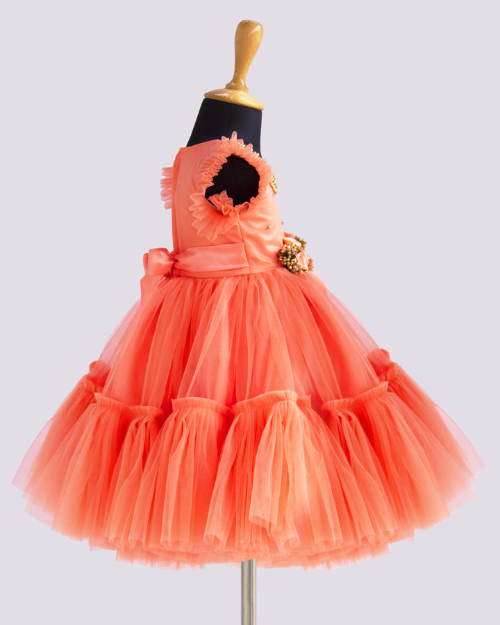 Coral Peach Shade Handwork Flower Frock
Material: Coral peach shade handwork flower frock is made with soft nylon net fabric. The yoke portion of the frock is designed with handwork design. Golden colour