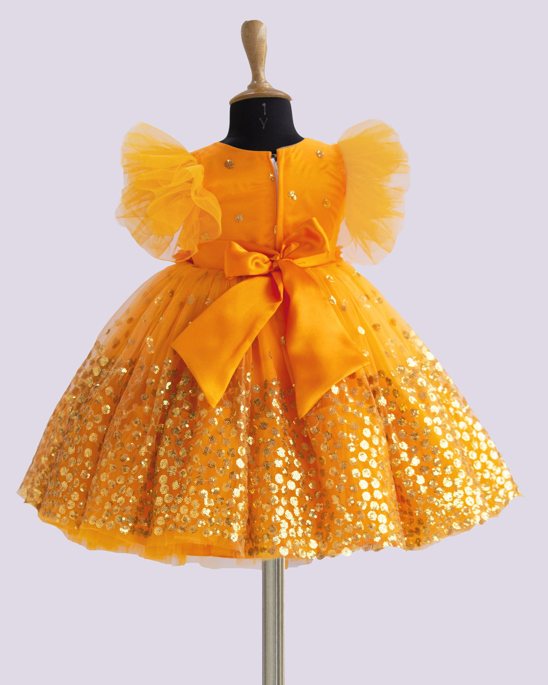 Mango Yellow Shade Heavy Sequins Party-wear Frock
Material : Mango Yellow Shade heavy sequins fabric net is used in the upper portion of the skirt. In the second layer pleated net is used for the grand and puffy lo