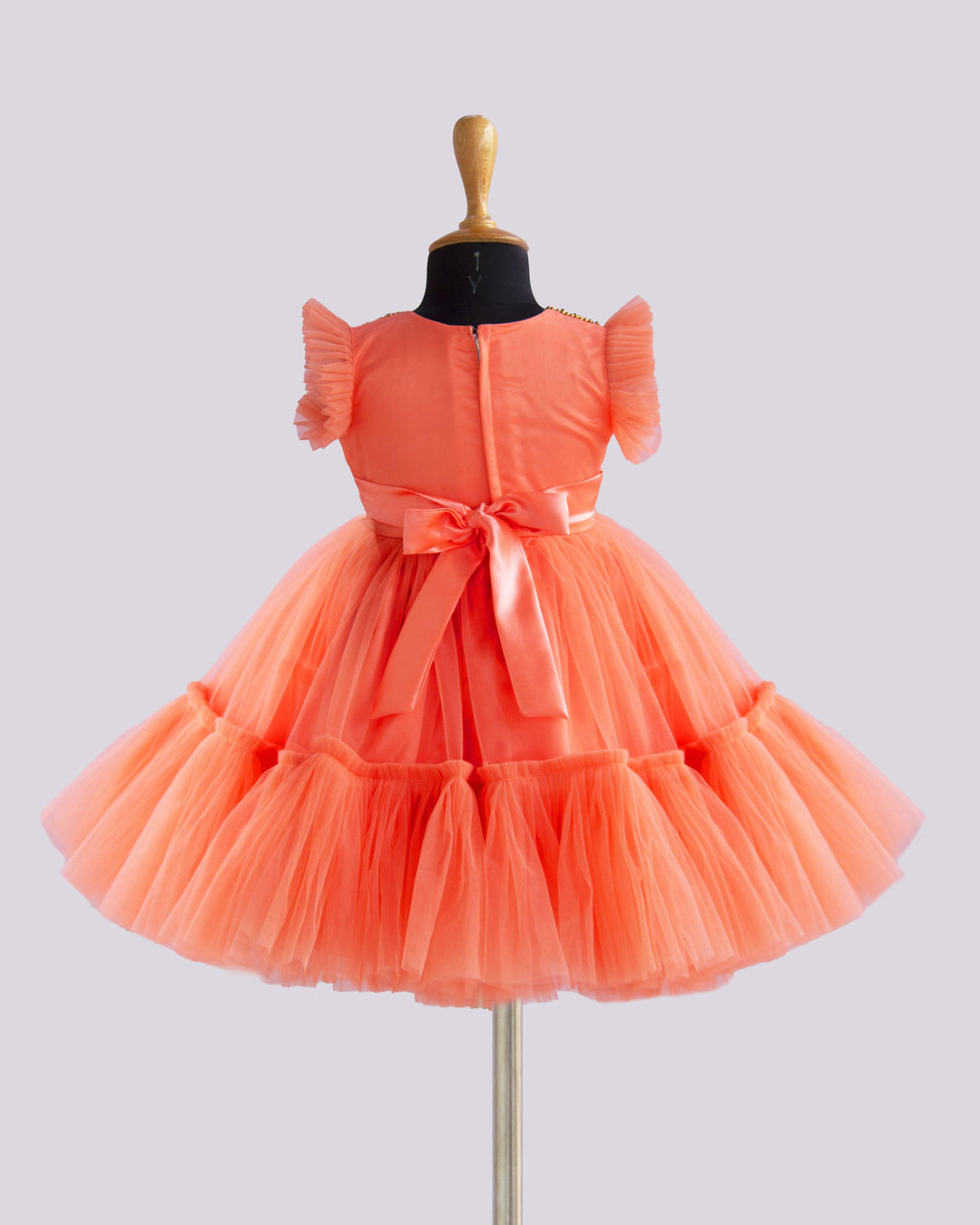 Coral Peach Shade Handwork Flower Frock
Material: Coral peach shade handwork flower frock is made with soft nylon net fabric. The yoke portion of the frock is designed with handwork design. Golden colour