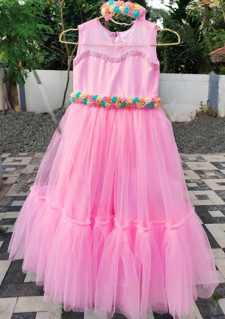 Babypink Shade Ruffled Long Gown 
Fabric: Baby pink colour soft nylon net, Same net is ruffled on the bottom portion. Neck is beautifully designed with same colour sugar beads.. Centre portion is