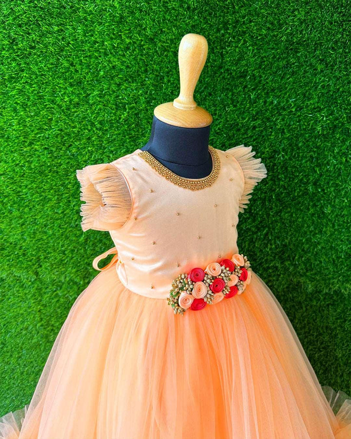 Light Peach Hand Embroidery Flower Gown- Matching Hair Band.
Material : Light Peach Colour long Gown. Light peach colour net is the main material of the gown.Golden beaded hand work is done on the neck portion and beads sprea