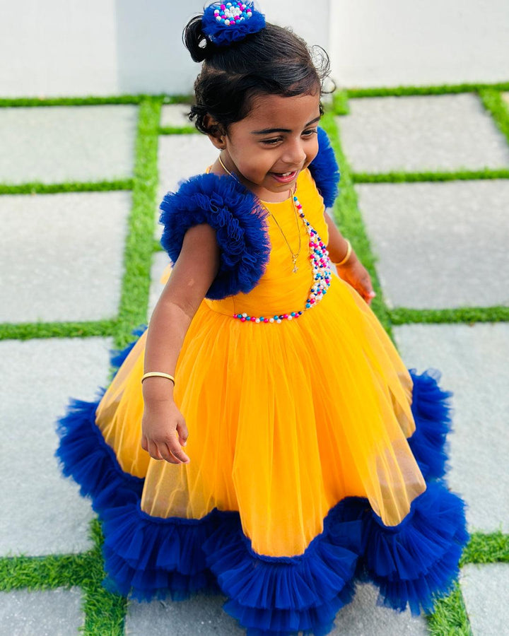 Sun Yellow & Navy blue combo Paris Handwork Birthday Gown
Material: Sun Yellow & Navy blue soft nylon net is used for making this beautiful Gown .Yoke portion of the gown is designed with yellow net with multi colours