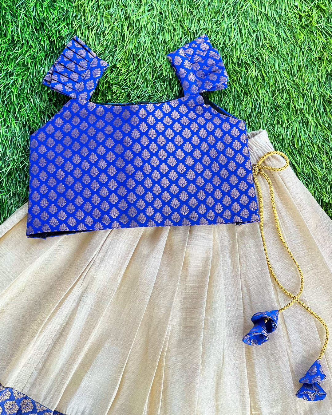 Baby girl in cream and royal blue Kerala Kasavu lehenga birthday dress