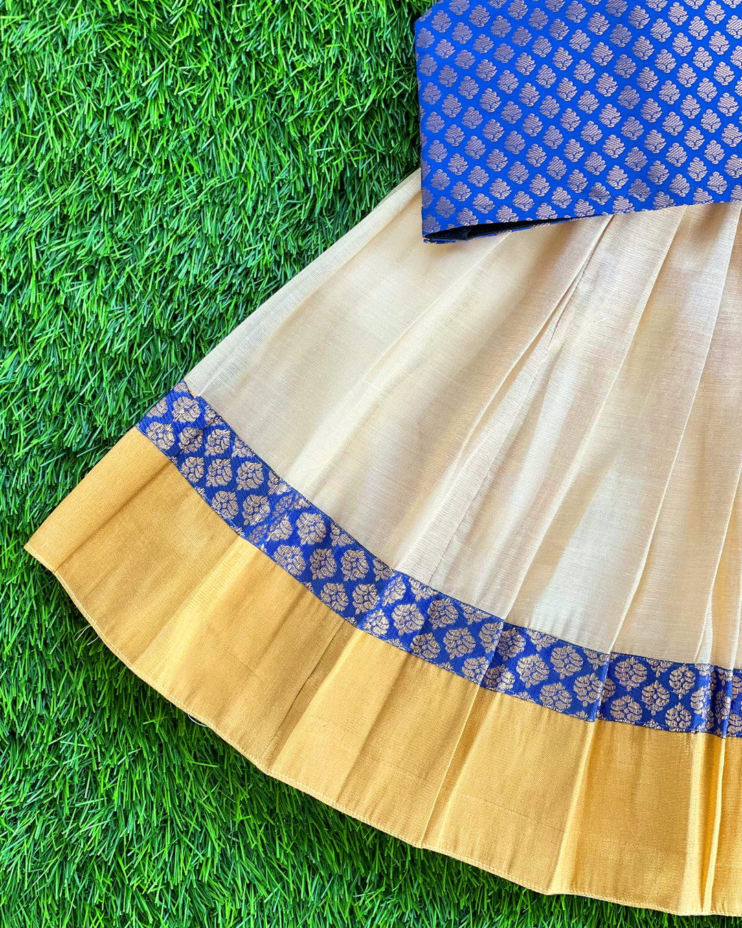 Baby girl in cream and royal blue Kerala Kasavu lehenga birthday dress