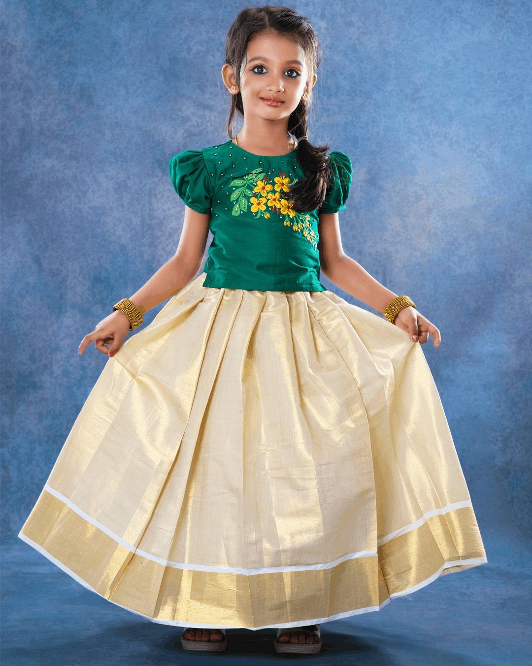 Cream & GreenTraditional Handwork Embroidery Lehenga Choli
Material: Cream colour kerala soft tissue silk fabric with dark green shade slub silk fabric with one side hand embroidery pattern and highlighted with glass beads