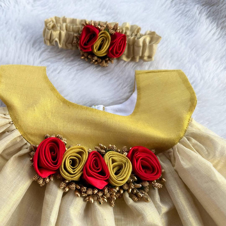 Cream & Gold Kerala Traditional Tissue frock - Matching Hairbad
Material: Cream shade kerala kasavu handloom fabric. Center portion is highlighted with red & golden flowers with pollens attached. Beautifully designed outfit