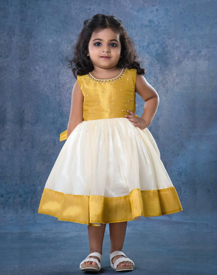 Cream & Gold handwork Traditional Knee Length Frock
Material:  Cream & Gold soft quality net with premium cream ultra satin inside for shining, Meroon silk material with hand embroidery beads on the neck and body