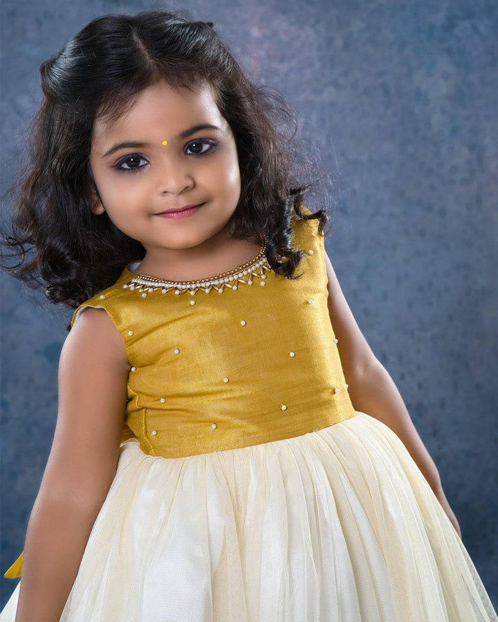 Cream & Gold handwork Traditional Knee Length Frock
Material:  Cream & Gold soft quality net with premium cream ultra satin inside for shining, Meroon silk material with hand embroidery beads on the neck and body