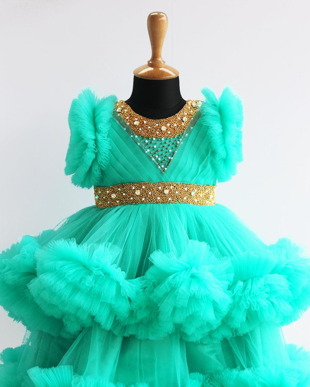 Sea Green Handwork Two Layer Ruffled Frock
Material: Sea Green Shade Pleated Ruffled Frock mono net with layered and ruffles on the end portion. Yoke portion is designed with pleated pattern and golden beade