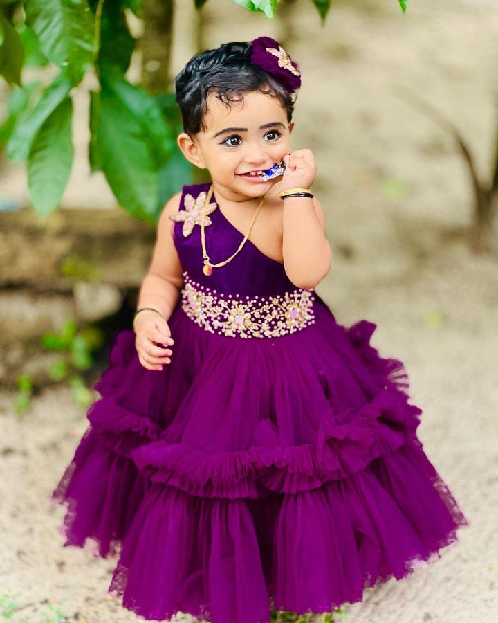 Aishu's Purple Shade Pleated Ruffled Frock
Material: Aishu's Purple Shade Pleated Ruffled Frock mono net with layered and ruffles on the end portion. Yoke portion is designed with pleated pattern and a handw
