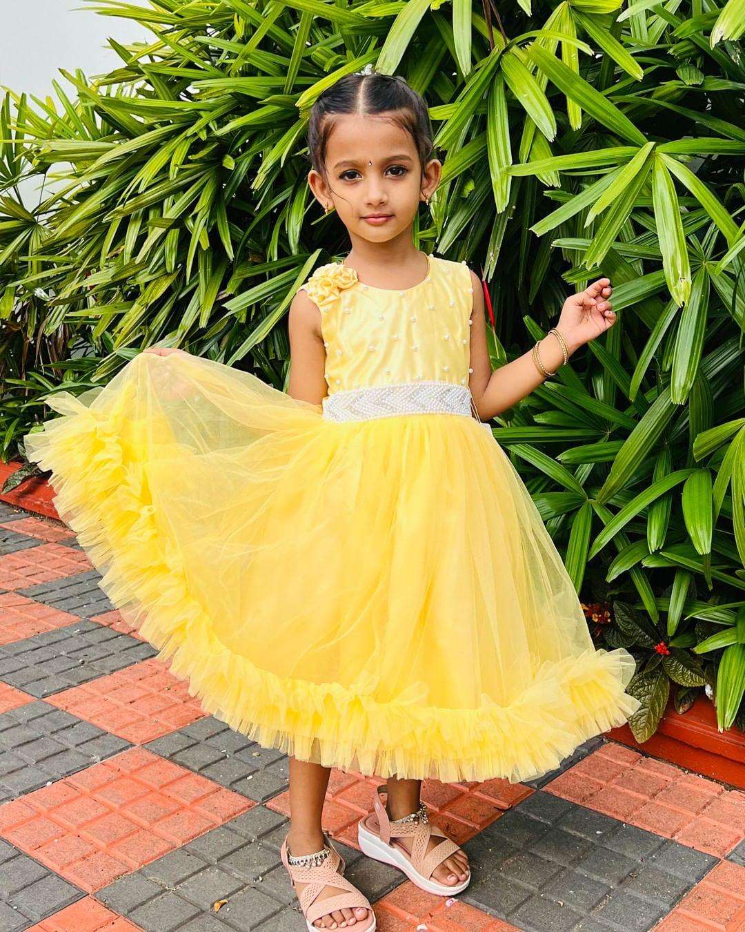 Yellow Ruffled Beaded Frock with Flowers
Material: Yellow nylon mono net with inner portion is covered with premium ultra satin and white cotton lining.
Colour: Yellow | Sleeve Type: Sleeveless | Item Leng