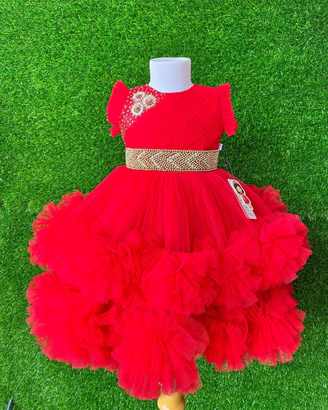 Red Layered Pleated Heavy Ruffled Hand embroidery Birthday Frock

Material: Bright red nylon mono net with layered and ruffles on the end portion. Yoke portion is designed with pleated pattern and a handwork in the centre portion