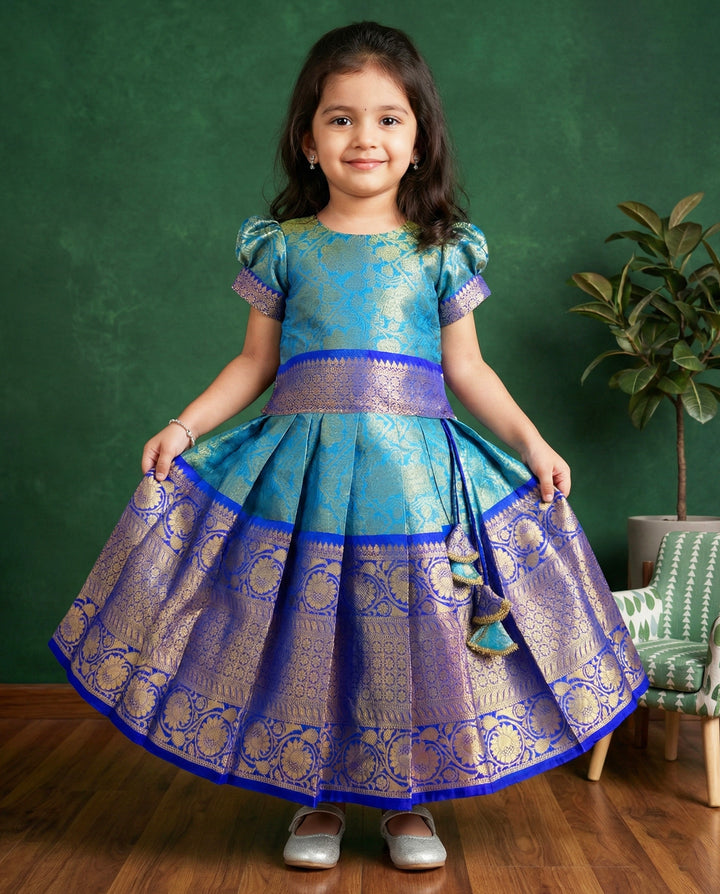 Peacock blue Banarasi silk lehenga choli for baby girls

Traditional puff sleeve dress for kids

Banarasi silk birthday dress for girls

Baby girls ethnic wear lehenga

Festive partywear dress for toddlers

Peacock blue traditional frock for baby girls

Stanwells Kids Banarasi birthday collection