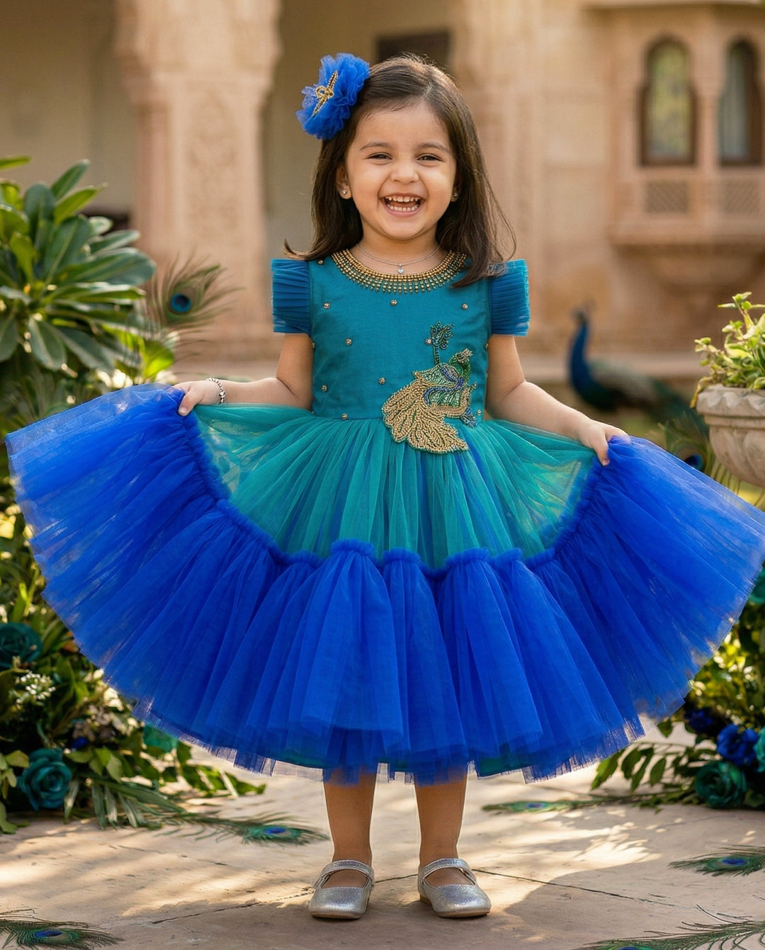 Peacock theme Applique Party wear Frock.
Material: Royal blue and Tourqise green colour net is using in the main portion of the dress. Royal blue colour net is pleating in the bottom portion. Over all colo