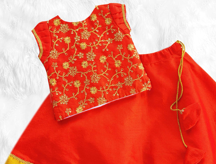 Orange Silk Thread Embroidered Traditional Lehenga Choli SetFabric: Orange Fantom silk material with a detailing thread embroidery and golden border on the end portionColour: Orange | Sleeve type: Puff Sleeves| Neck type: Rou