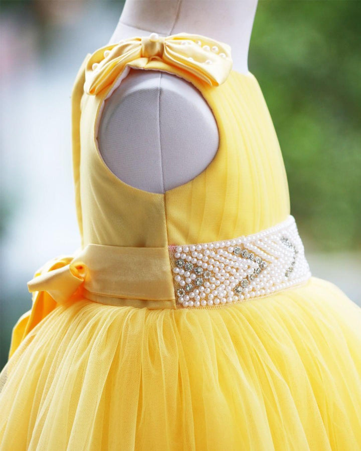 Yellow Ruffled Pleated Bow Frock
Material:  Yellow nylon mono net with inner portion is covered with premium ultra satin and white cotton lining.
Colour: Yellow | Sleeve Type: Sleeveless | Item Len