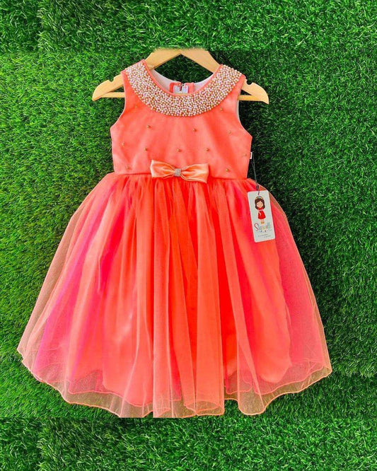 Tomato Coral Beaded Neck Knee-length Frock
Material: Tomato Coral Shade Frock mono net in the end portion. Yoke portion is designed with handwork pattern with neck fully designed with beads.  Center portion 