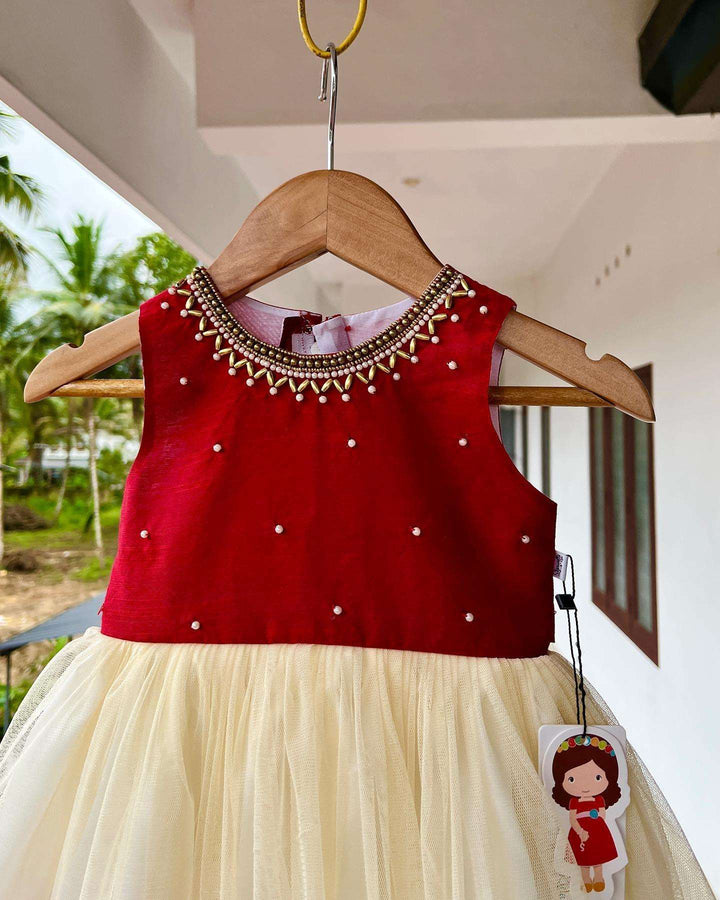 Cream & Meroon Traditional Handwork Kerala Frock
Material:  Creamish golden soft quality net with premium cream ultra satin inside for shining, Meroon silk material with hand embroidery beads on the neck and body 