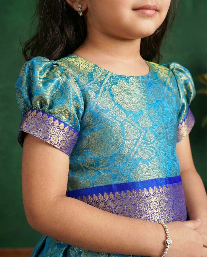Peacock blue Banarasi silk lehenga choli for baby girls

Traditional puff sleeve dress for kids

Banarasi silk birthday dress for girls

Baby girls ethnic wear lehenga

Festive partywear dress for toddlers

Peacock blue traditional frock for baby girls

Stanwells Kids Banarasi birthday collection
