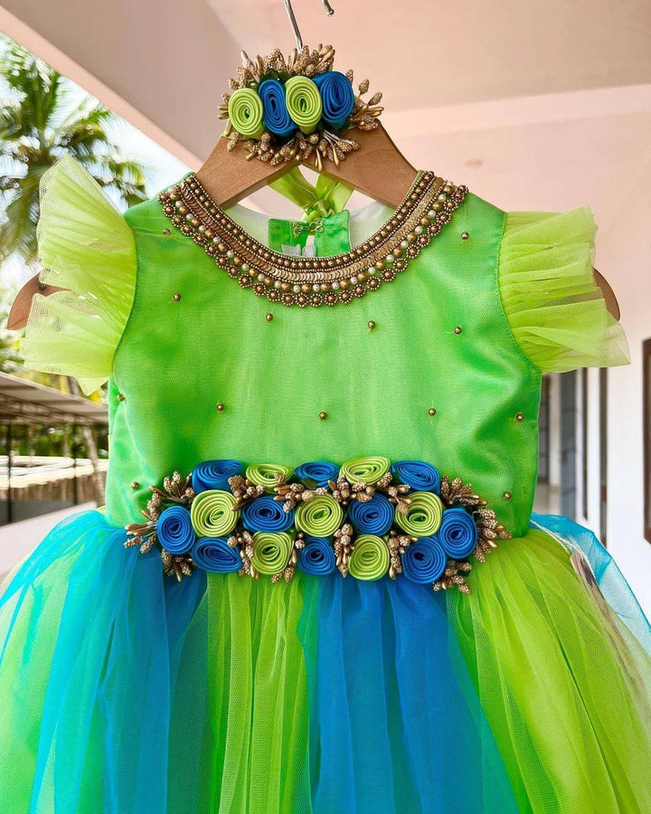 PistaGreen & SkyBlue combo Handwork Flower Frock
Material: Pistagreen &amp; Skyblue shade mono nylon net fabric with premium glossy satin as lining. Inner portion is covered with premium ultra satin and white cott