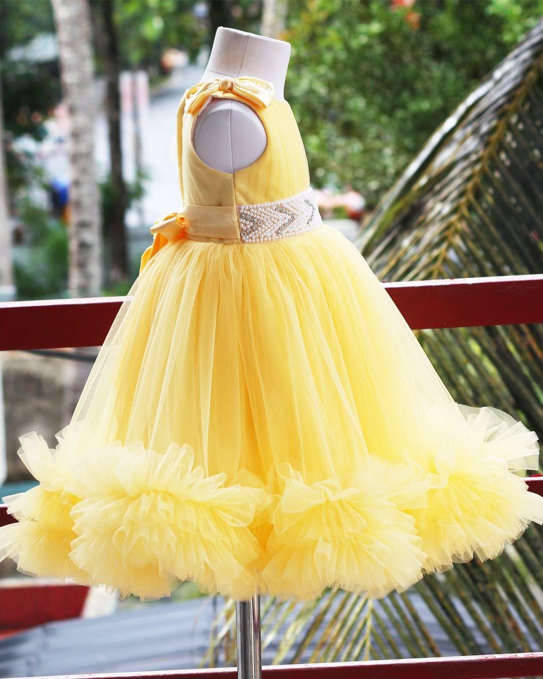 Yellow Ruffled Pleated Bow Frock
Material:  Yellow nylon mono net with inner portion is covered with premium ultra satin and white cotton lining.
Colour: Yellow | Sleeve Type: Sleeveless | Item Len