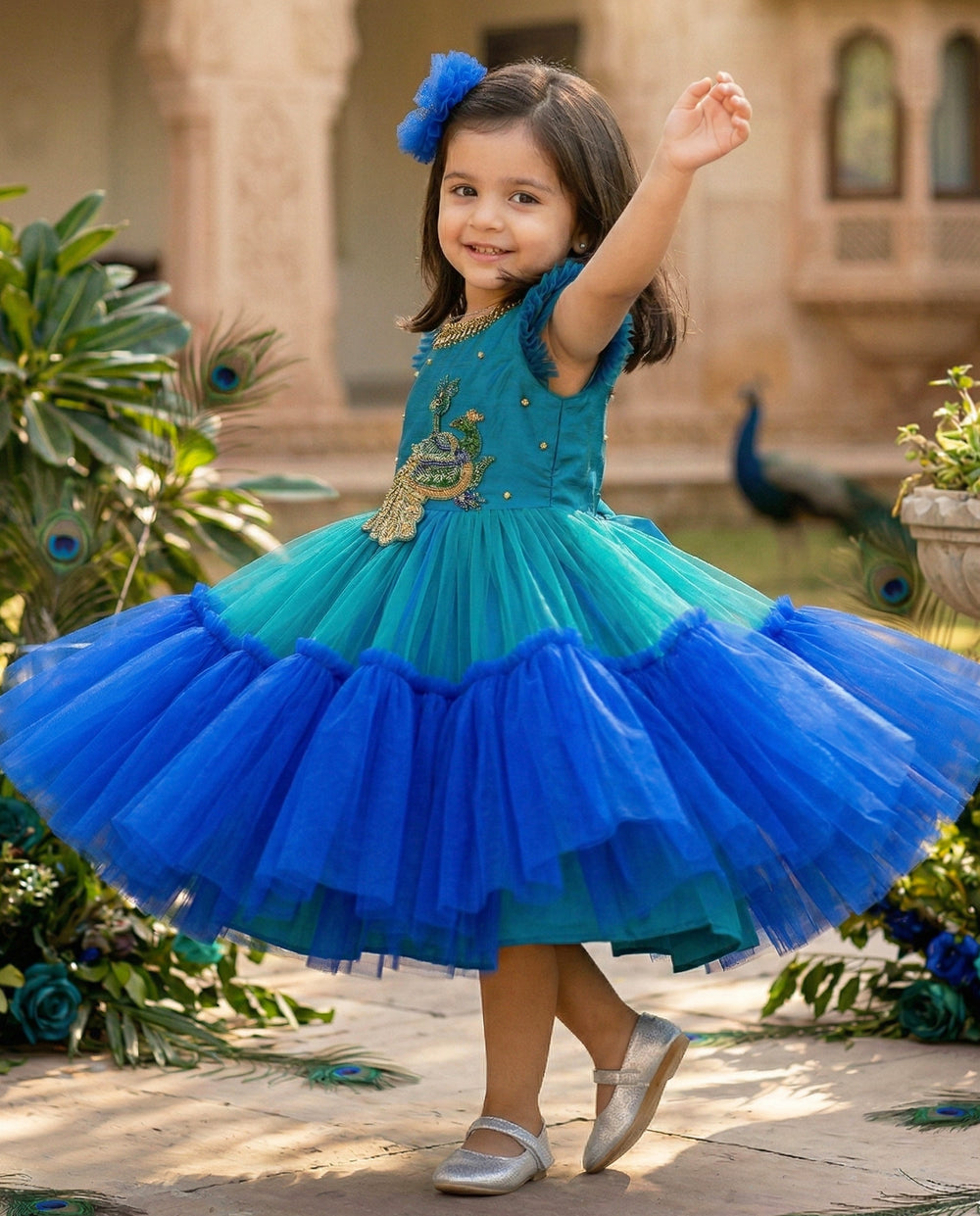 Peacock theme Applique Party wear Frock.
Material: Royal blue and Tourqise green colour net is using in the main portion of the dress. Royal blue colour net is pleating in the bottom portion. Over all colo