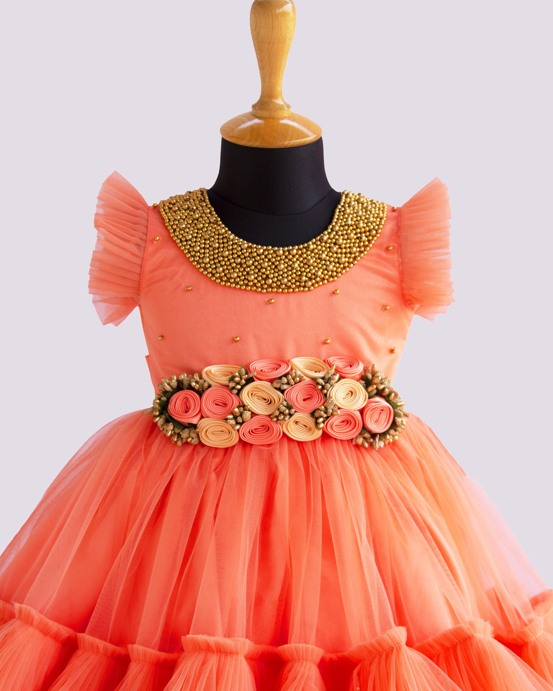 Coral Peach Shade Handwork Flower Frock
Material: Coral peach shade handwork flower frock is made with soft nylon net fabric. The yoke portion of the frock is designed with handwork design. Golden colour 