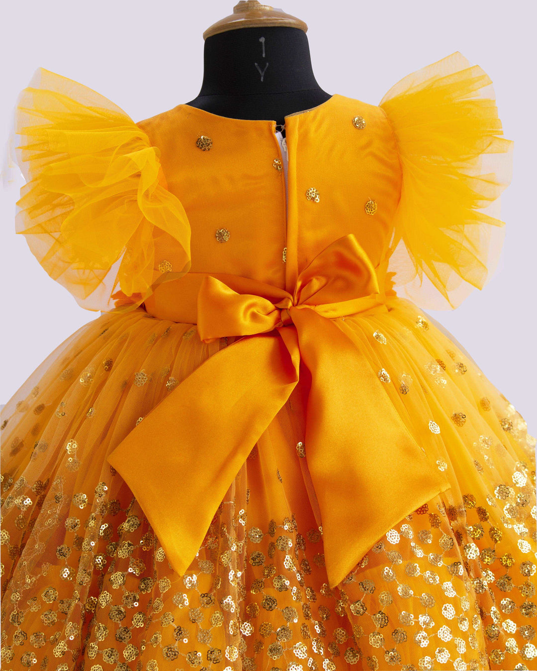 Mango Yellow Shade Heavy Sequins Party-wear Frock
Material : Mango Yellow Shade heavy sequins fabric net is used in the upper portion of the skirt. In the second layer pleated net is used for the grand and puffy lo