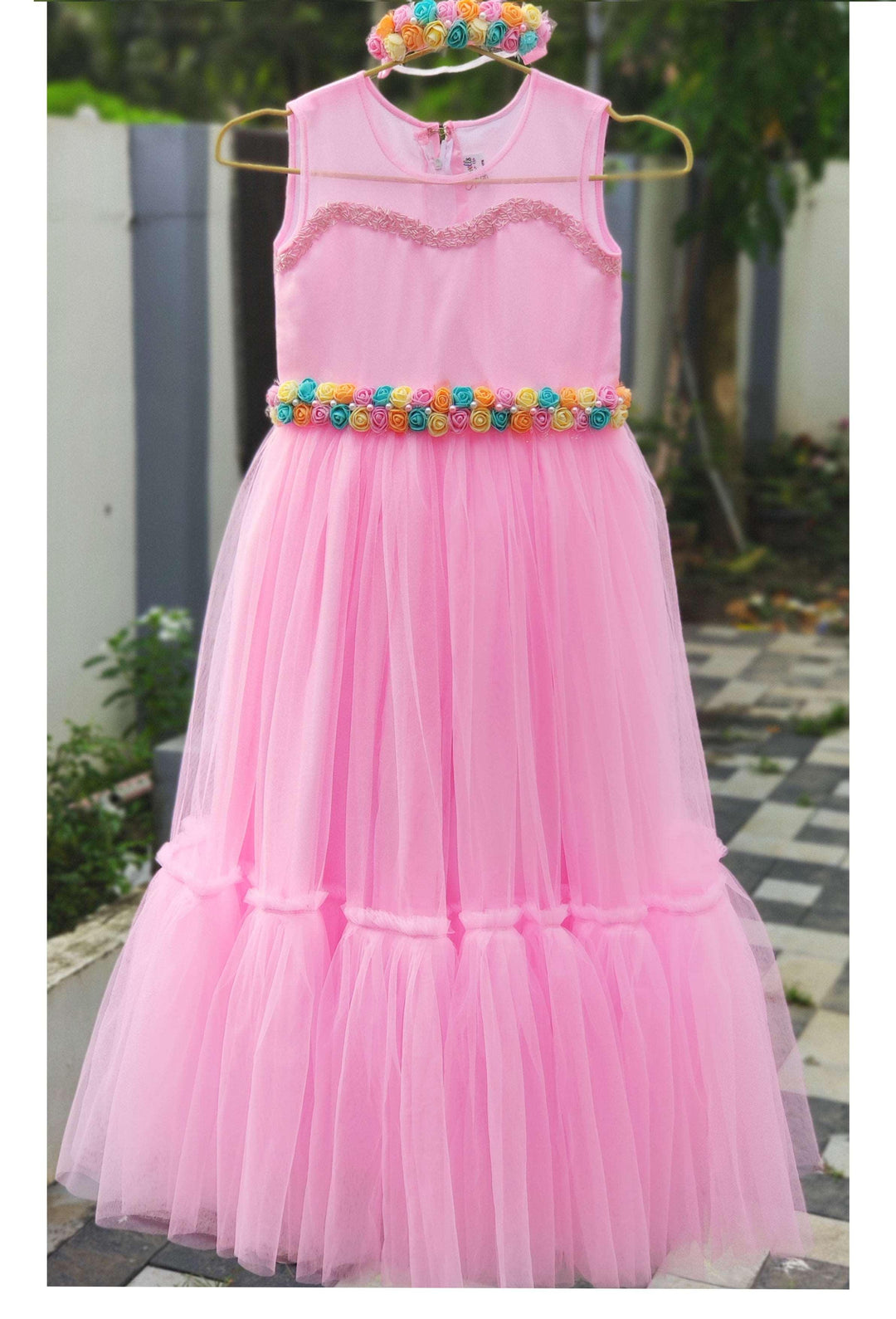 Babypink Shade Ruffled Long Gown 

Fabric: Baby pink colour soft nylon net, Same net is ruffled on the bottom portion. Neck is beautifully designed with same colour sugar beads.. Centre portion is 