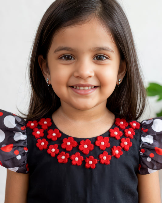 Red flower neckline detail on black satin polka top for baby girl – Stanwells Kids