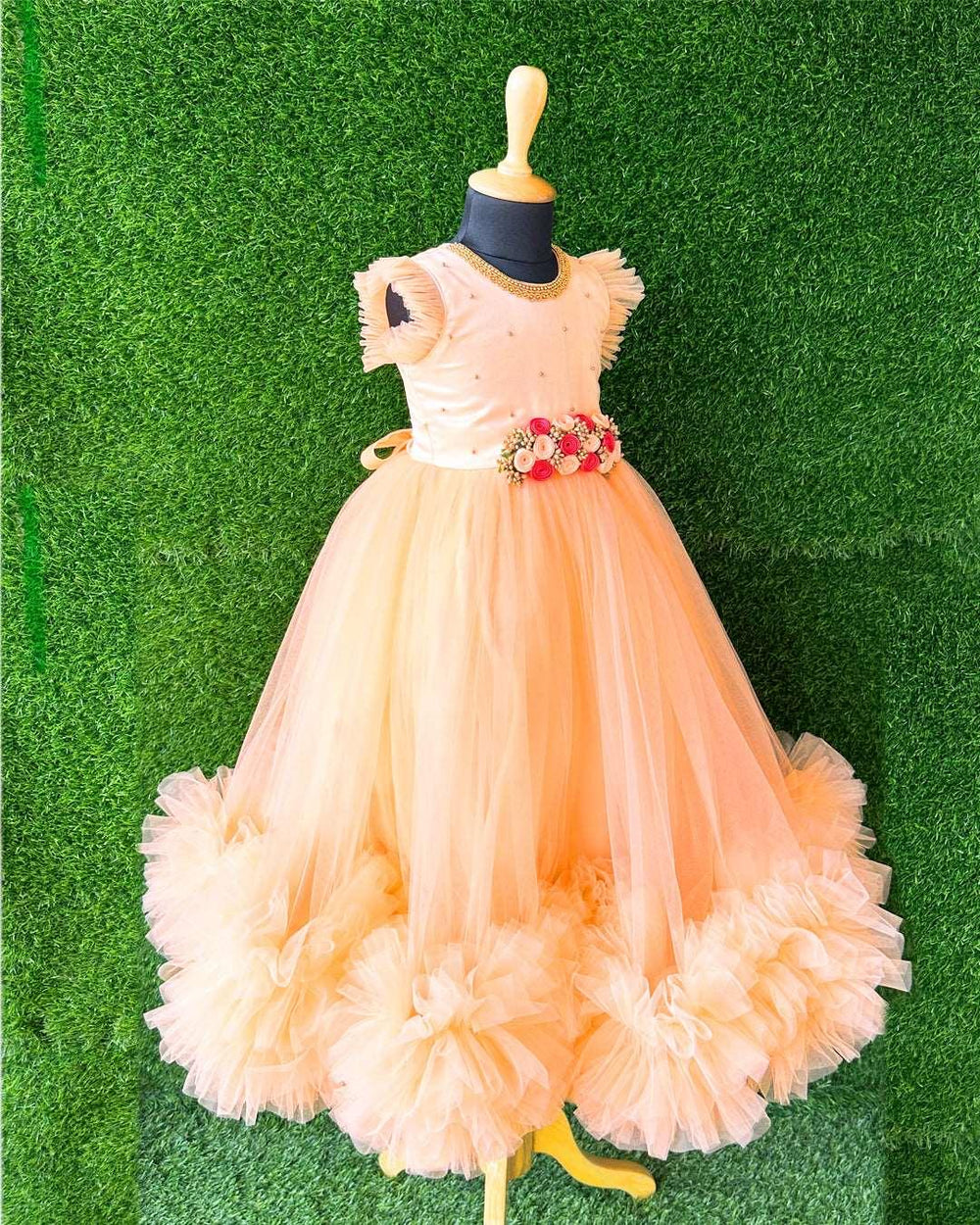 Light Peach Hand Embroidery Flower Gown- Matching Hair Band.
Material : Light Peach Colour long Gown. Light peach colour net is the main material of the gown.Golden beaded hand work is done on the neck portion and beads sprea