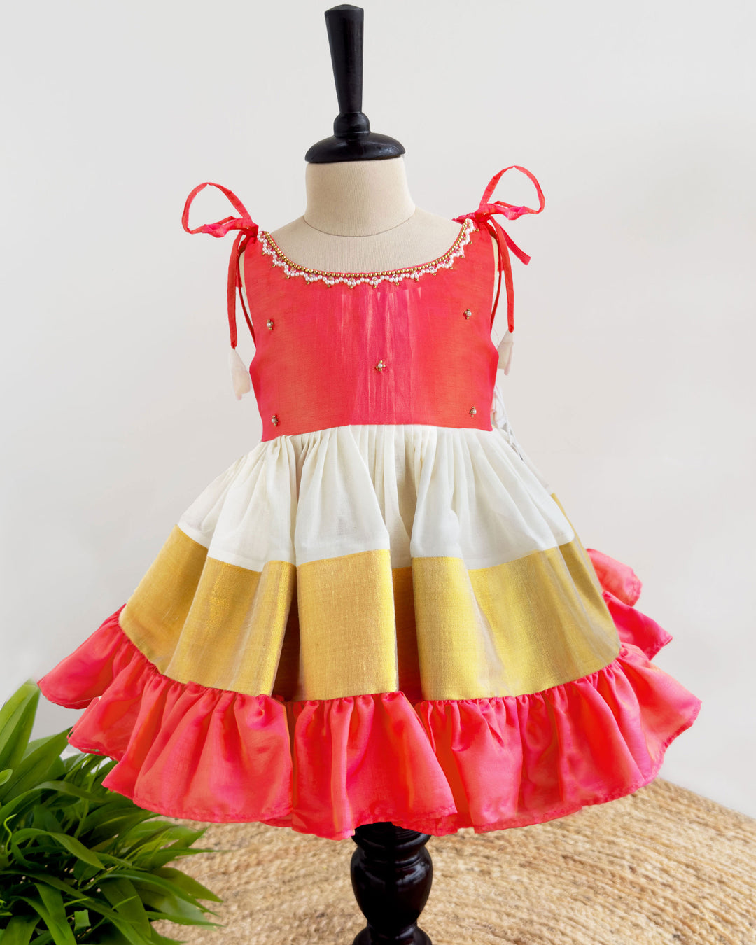 Front view of cream peach Kerala Kasavu Kettuduppu frock for baby girl