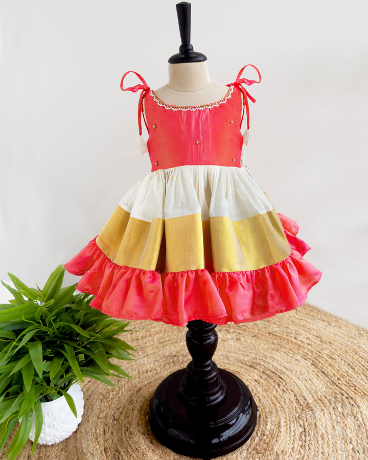 Front view of cream peach Kerala Kasavu Kettuduppu frock for baby girl
