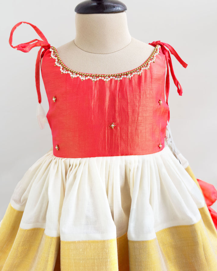 Detailed view of handwork on cream peach Kerala Kasavu frock for baby girl