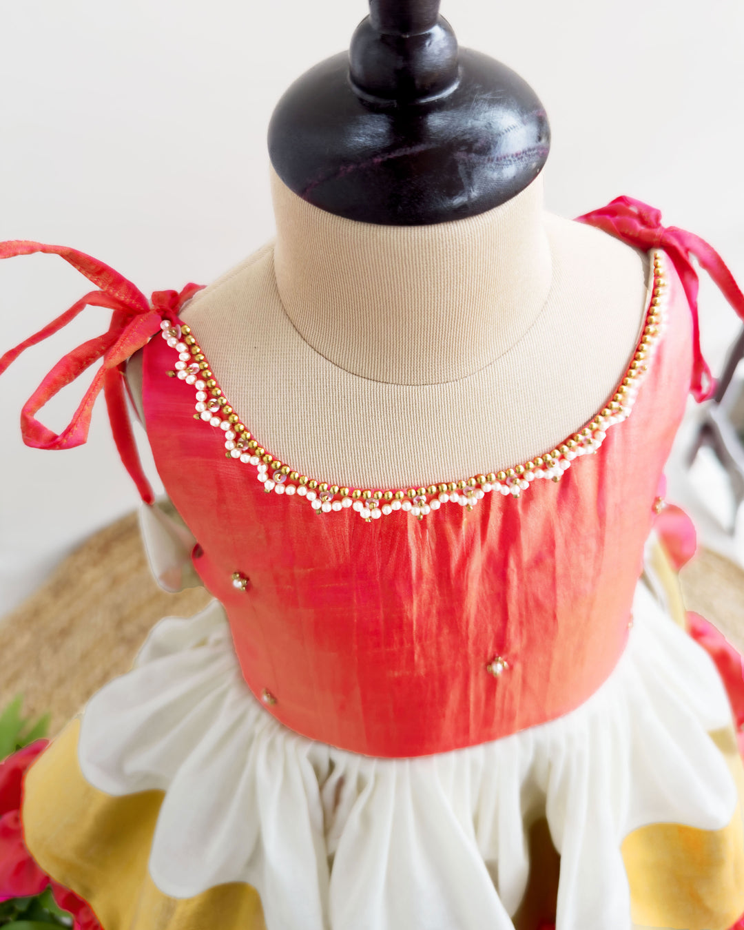 Detailed view of handwork on cream peach Kerala Kasavu frock for baby girl