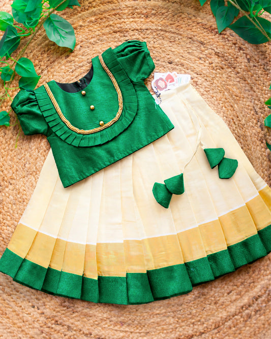 Cream green Onam special Kerala Kasavu lehenga choli for baby girl featuring an elegant traditional design by Stanwells Kids,front view