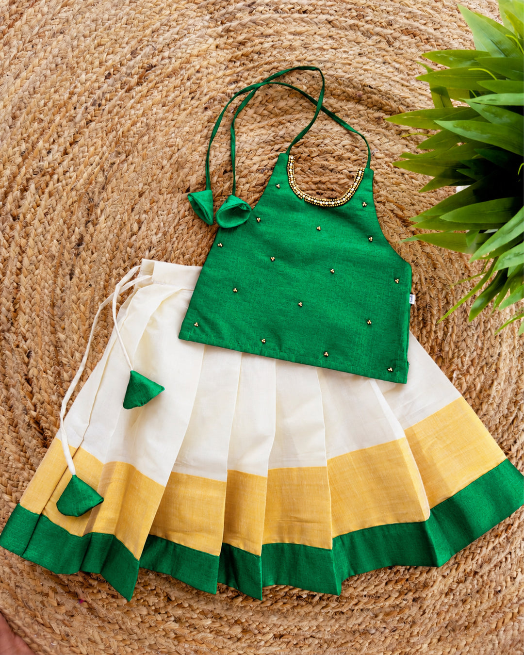 Cream green traditional Kerala Kasavu Onam lehenga choli for baby girl featuring an elegant ethnic design by Stanwells Kids.

