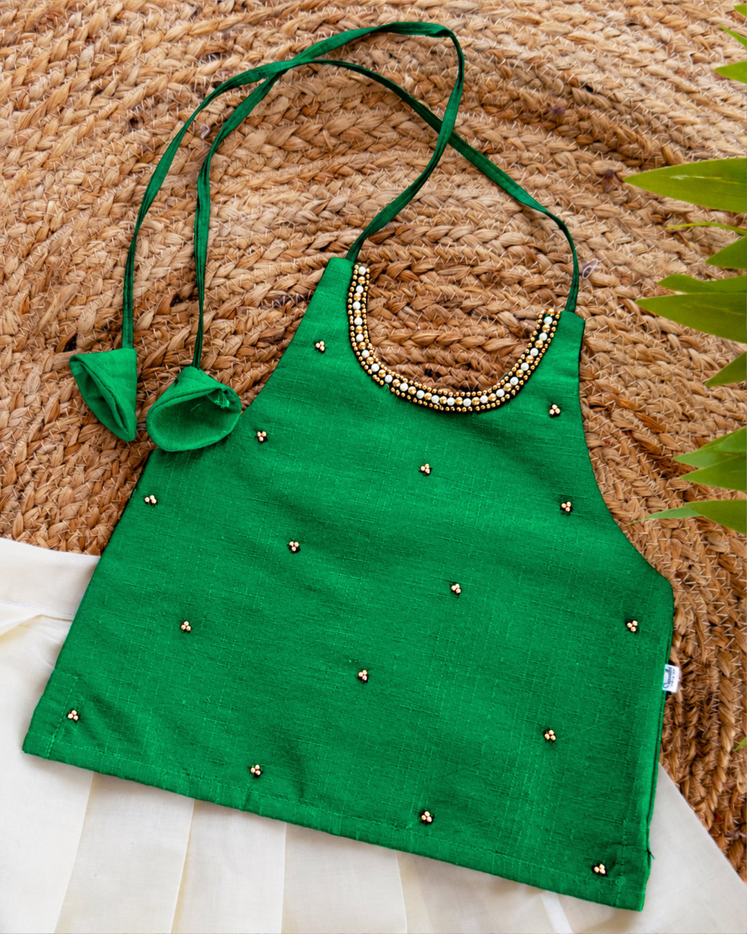 Close-up of the blouse of a cream green traditional Kerala Kasavu lehenga choli for baby girl.