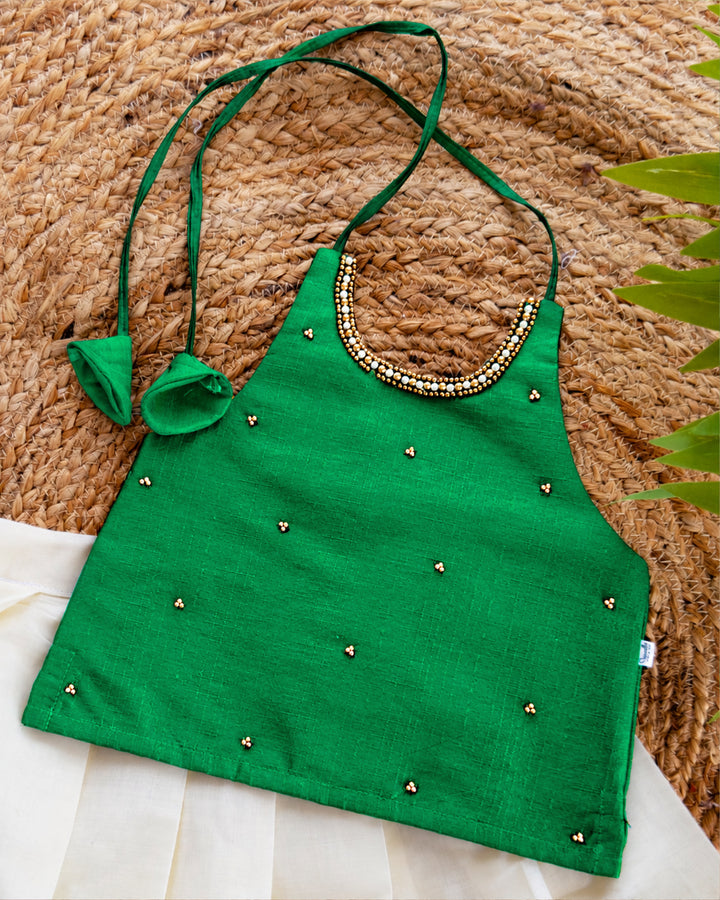 Close-up of the blouse of a cream green traditional Kerala Kasavu lehenga choli for baby girl.