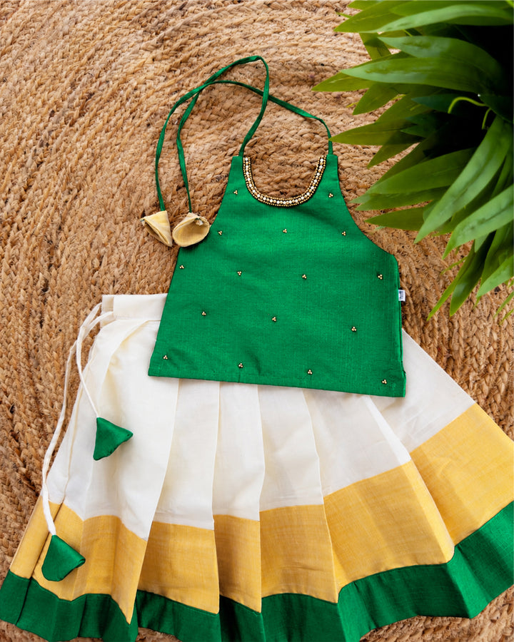 Cream green traditional Kerala Kasavu Onam lehenga choli for baby girl by Stanwells Kids, perfect for Onam, Vishu, and festive occasions.