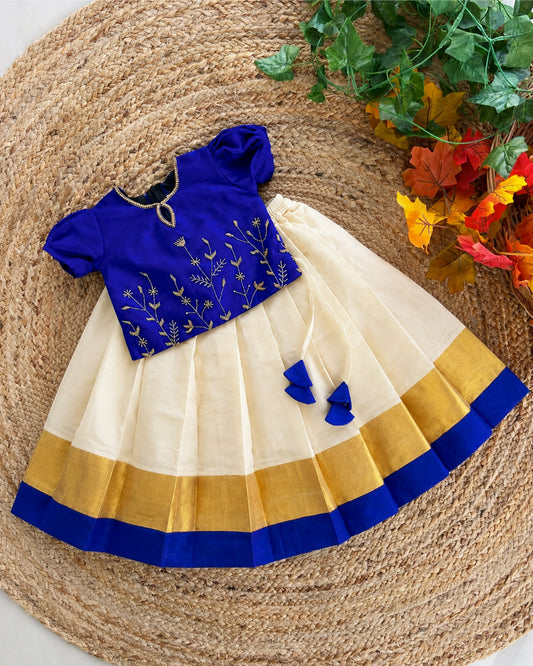 Front view of cream Kasavu lehenga with royal blue blouse