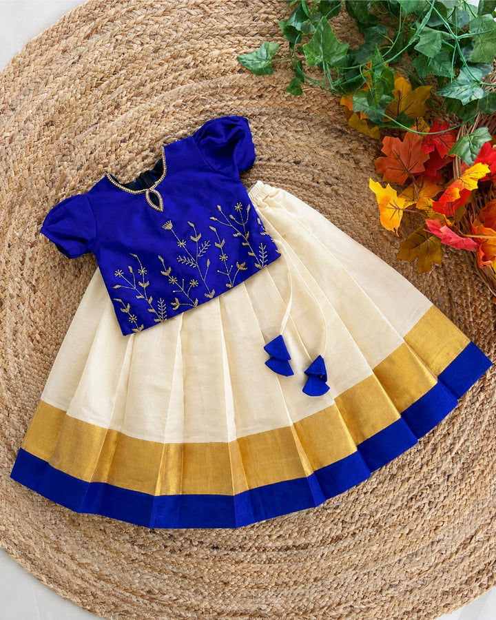Front view of cream Kasavu lehenga with royal blue blouse