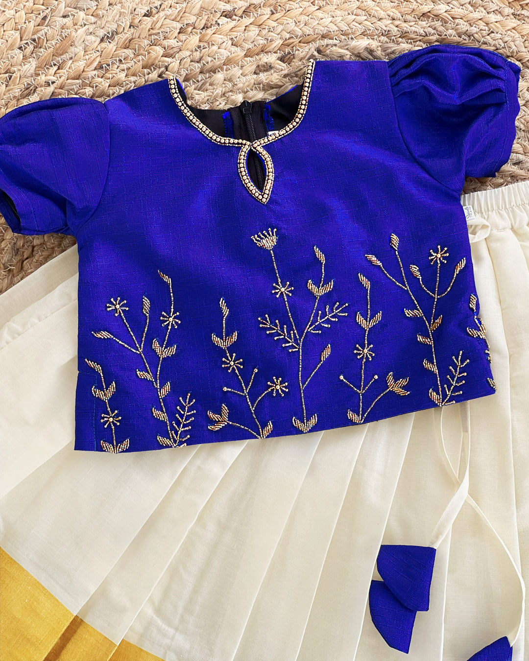 Front view of cream Kasavu lehenga with royal blue blouse
